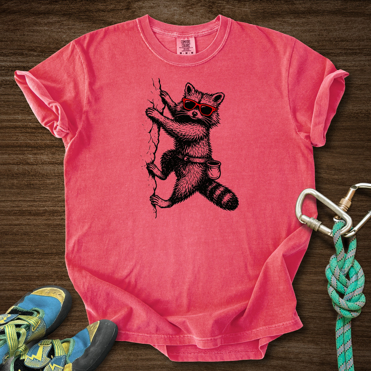 Raccoon Chillin Up a Cliff Premium in Watermelon — flat lay mockup