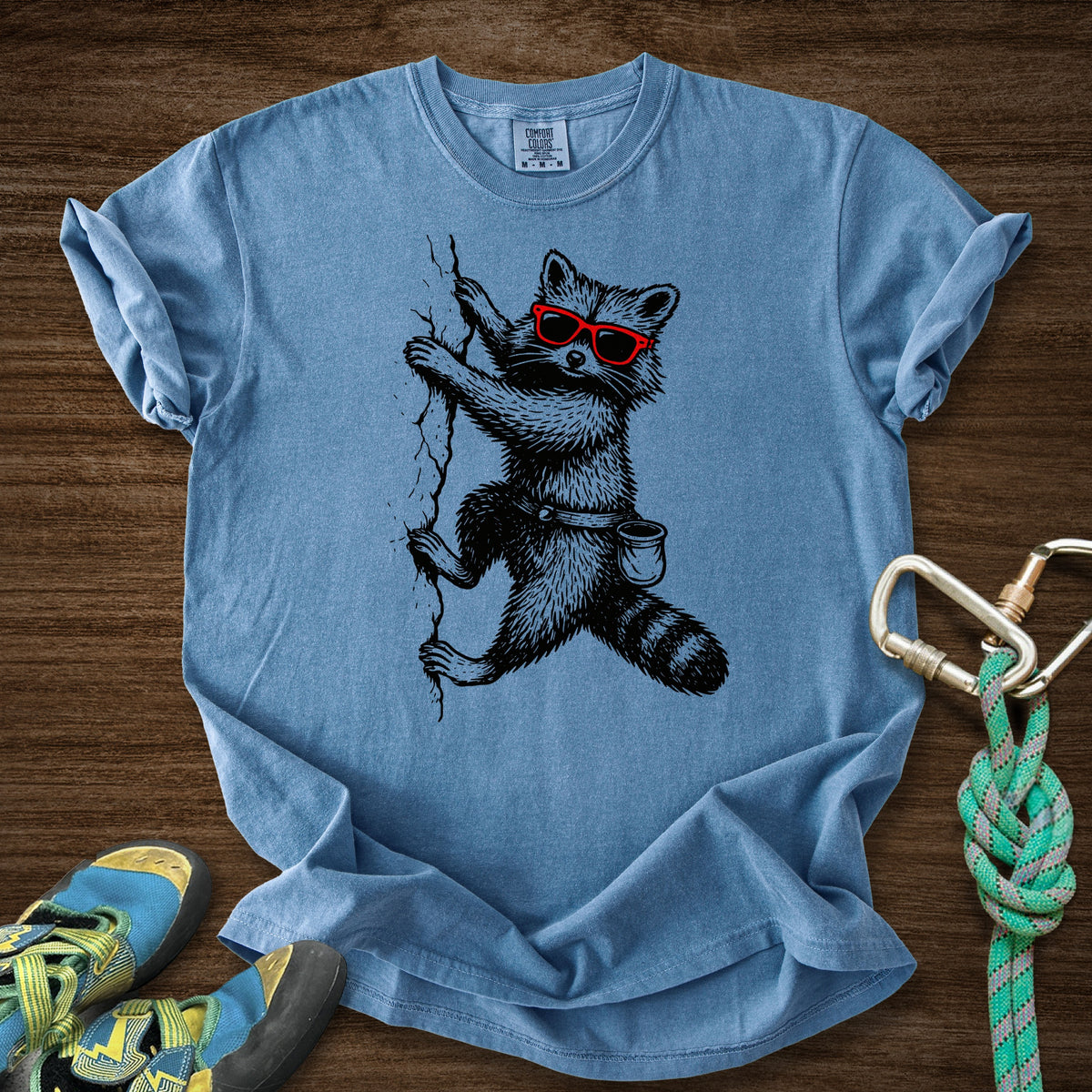 Raccoon Chillin Up a Cliff Premium in Blue Jean — flat lay mockup